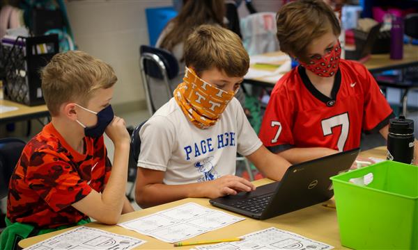 Boys work on Escape Room problems